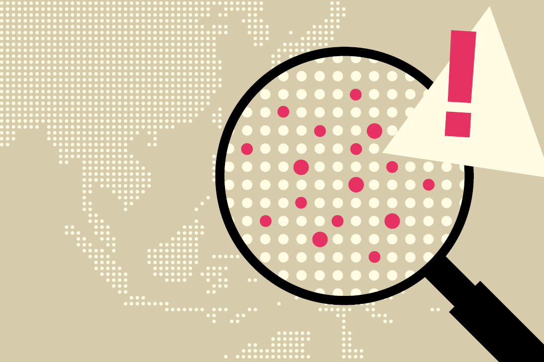 A magnifying glass showing hot spot areas on a world map