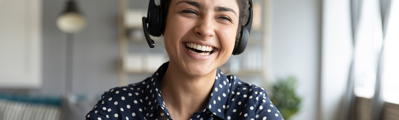 A woman on a work call and laughing A woman on a work call and laughing