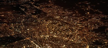 A city with lights as shown from an aero plane