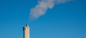 Smoke coming out of a chimney on a building Smoke coming out of a chimney on a building