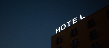 Hotel Sign lit up on top of a hotel building