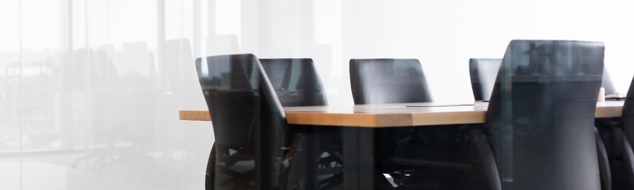 An empty conference room with a table and chairs