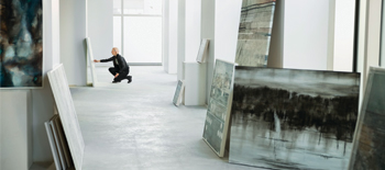 An art gallery with a visitor looking at a painting closely An art gallery with a visitor looking at a painting closely