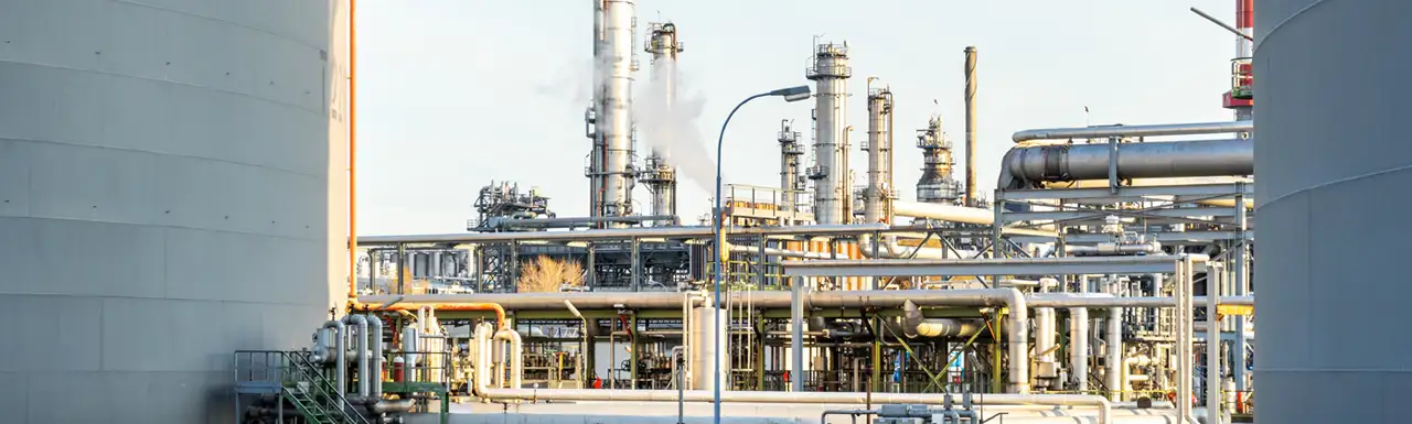 An industrial site with smoke coming out chimneys An industrial site with smoke coming out chimneys