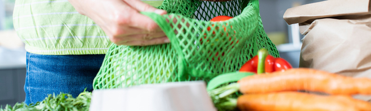 Vegetables on the table and some being packed in the bag