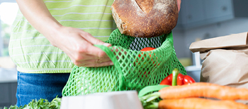 Vegetables on the table and some being packed in the bag Vegetables on the table and some being packed in the bag