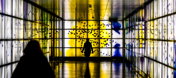 A digital art gallery and visitors in silhouette